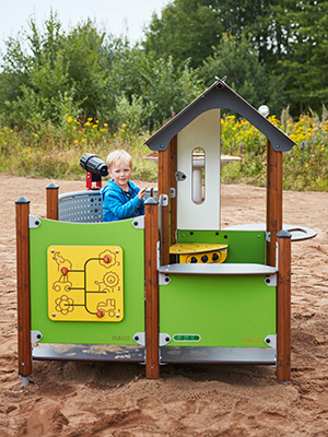 A young child is playing on a small playground unit.